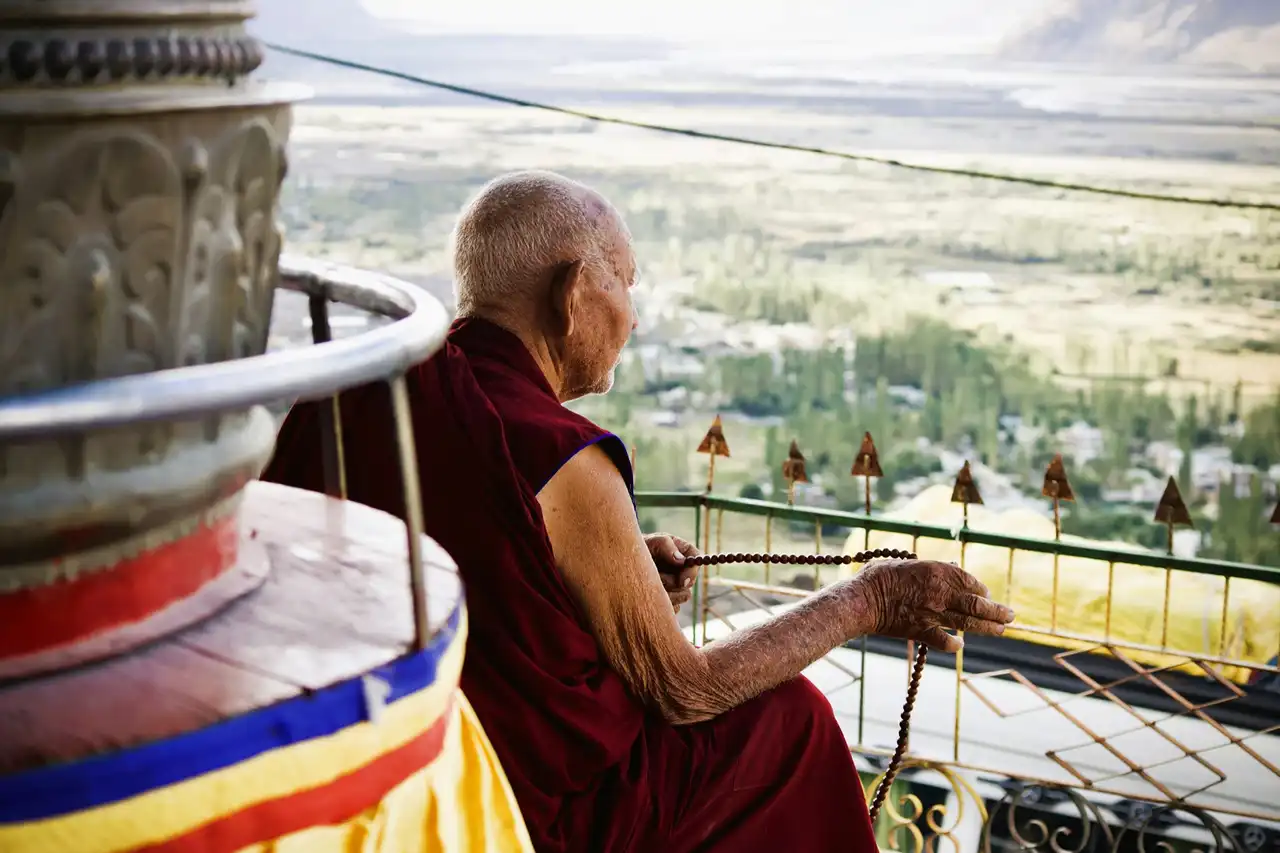 An elderly monk looking out over the Nubra valley from Diskit Monastery
