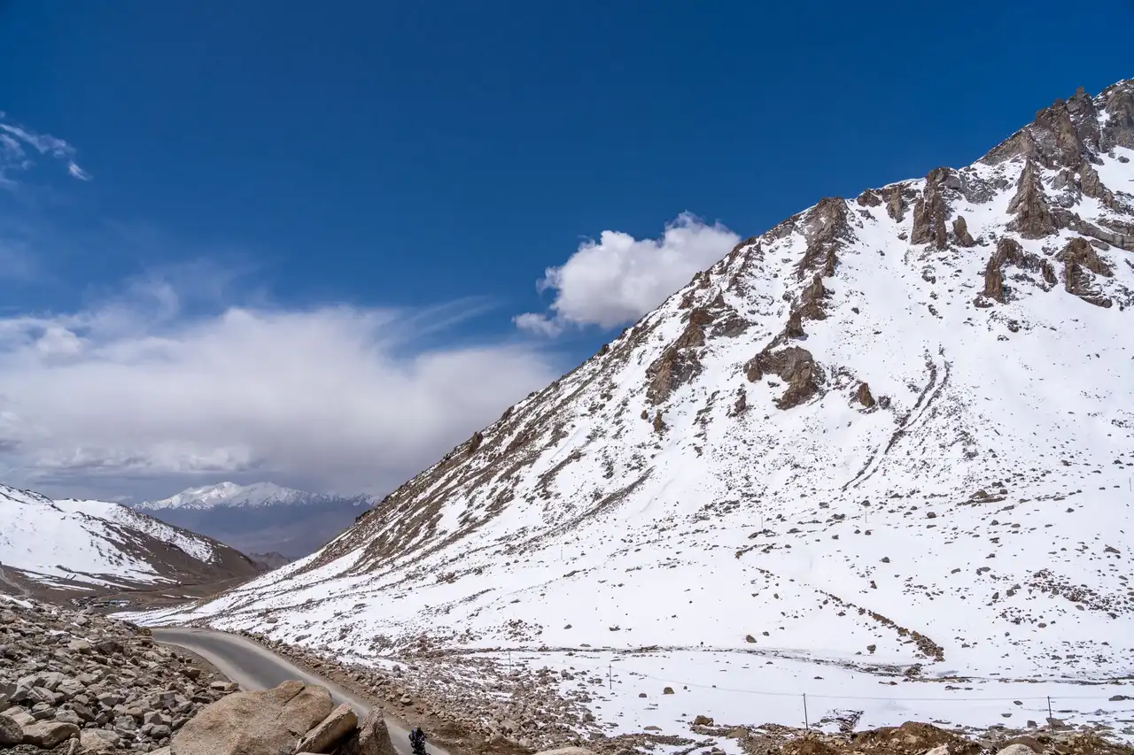 A road winding across a snow-covered slope near Leh