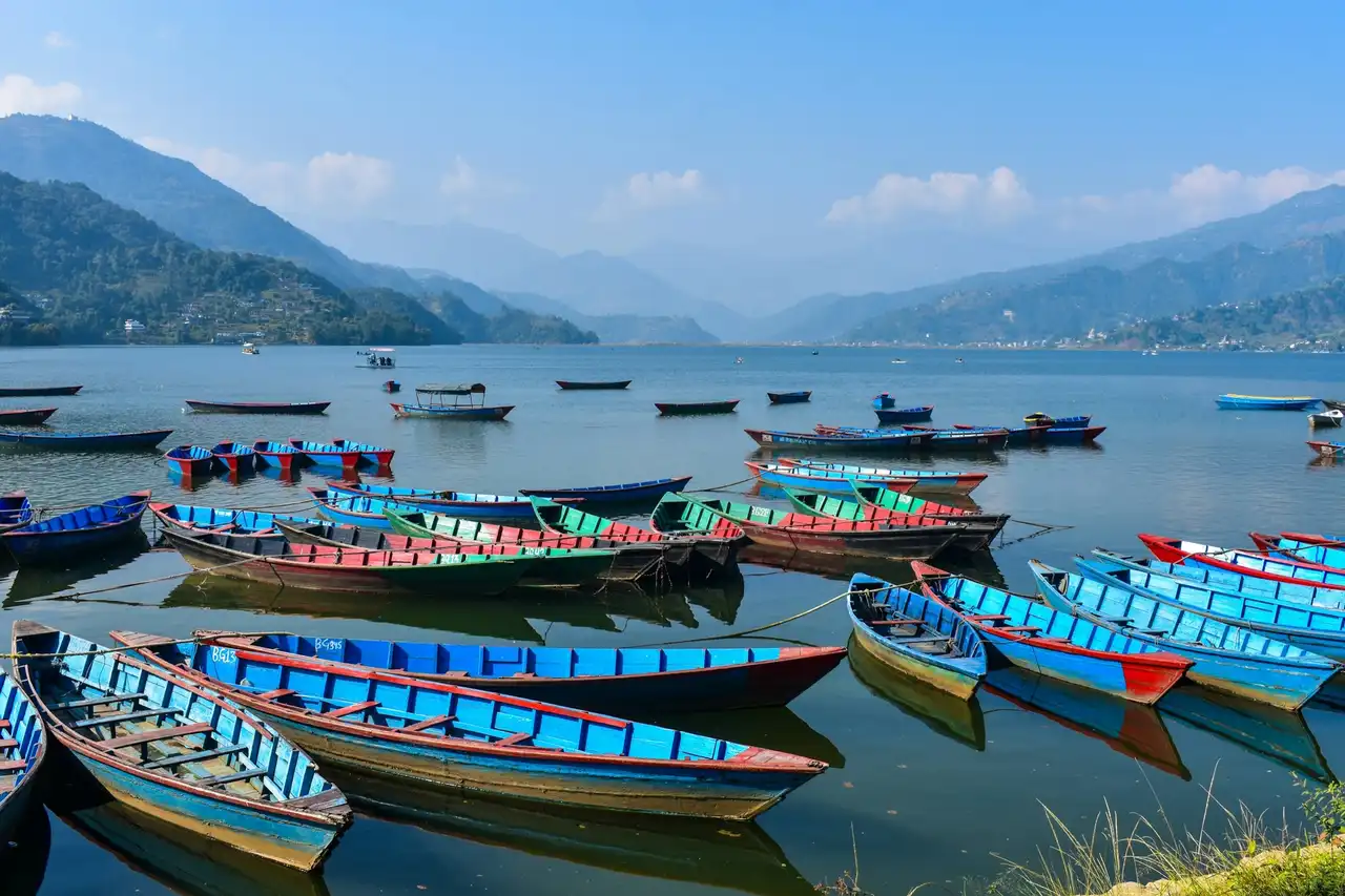 Brightly painted wooden boats on Phewa Lake in Pokhara